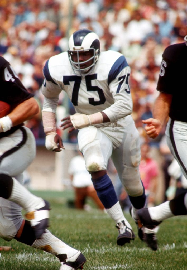 Deacon Jones, legendary defensive end for the Los Angeles Rams, in action during a game.