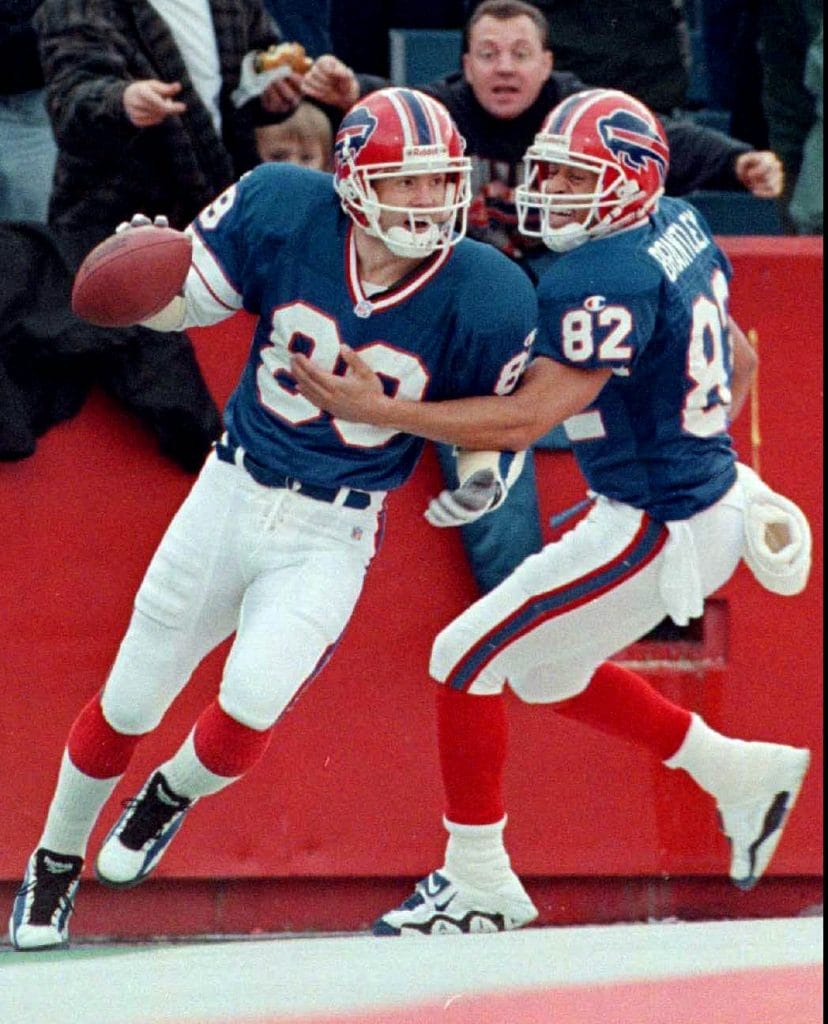 Don Beebe celebrating a touchdown in his Buffalo Bills uniform with a teammate.