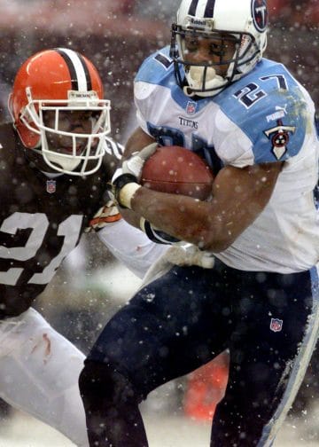 Tennessee Titans' Eddie George powers through the snow against the Cleveland Browns.