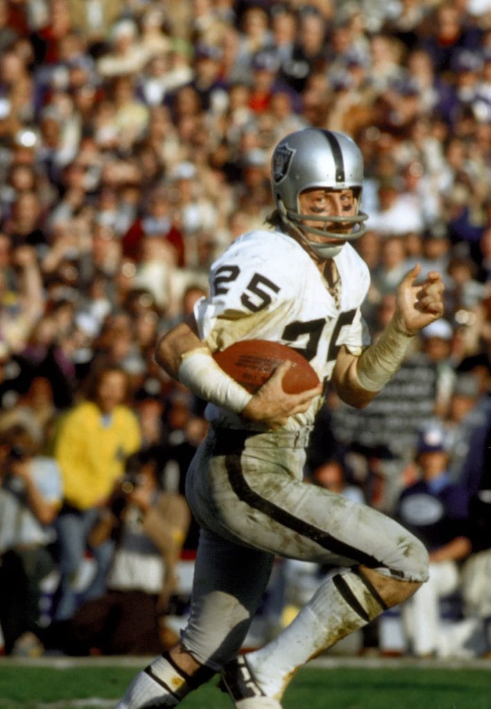 Fred Biletnikoff displaying his signature receiving skills, honored among elite white NFL players.