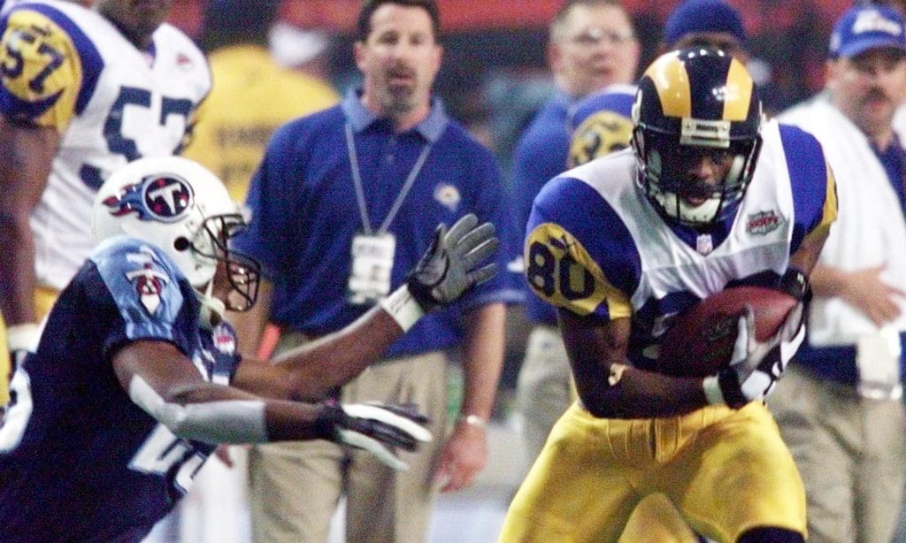 Isaac Bruce of the St. Louis Rams making a key play during the Super Bowl against the Tennessee Titans.