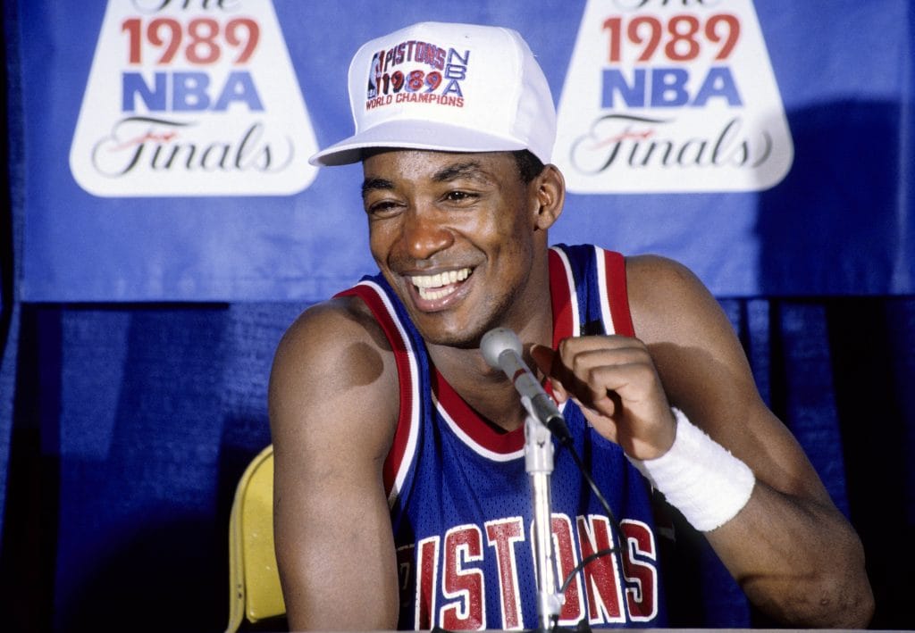 Isiah Thomas smiling during the press conference after the Detroit Pistons' 1989 NBA Finals victory.