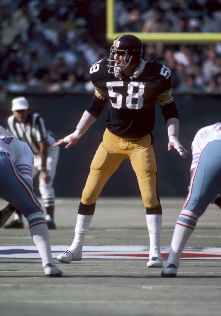 Jack Lambert of the Pittsburgh Steelers signaling defensive formations during a game.