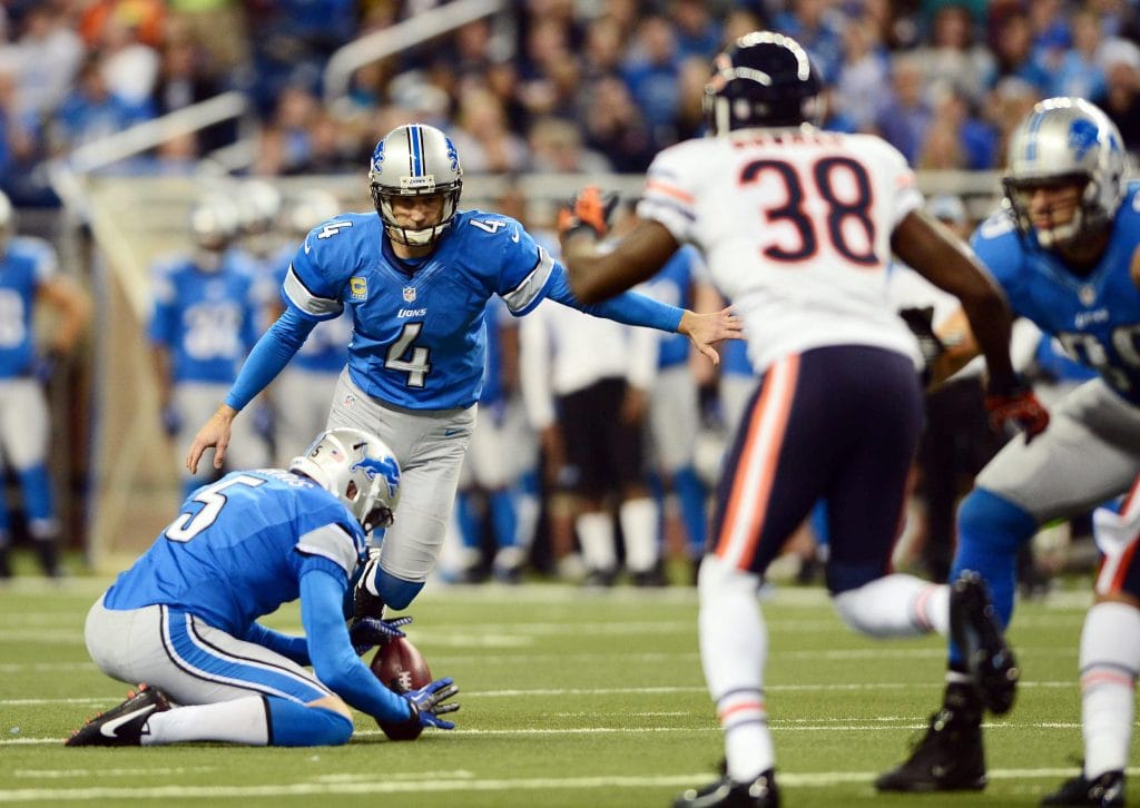 Detroit Lions kicker Jason Hanson setting up for a field goal during an NFL game against the Chicago Bears.