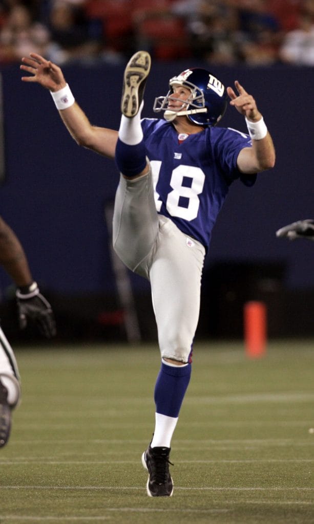 Jeff Feagles punting for the New York Giants during an NFL game.