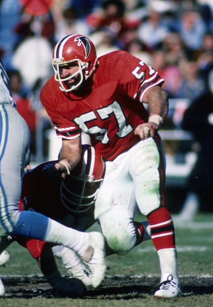 Jeff Van Note of the Atlanta Falcons, wearing jersey number 57, in a defensive stance during an NFL game."\