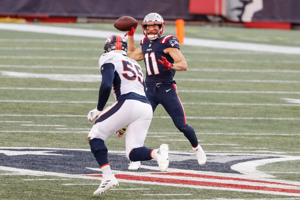 Julian Edelman throwing a pass during a game, representing famous white football players and highlighting his versatility as a white NFL player.