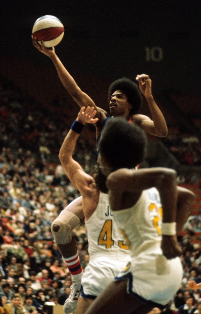 Julius Erving executing a stylish layup in an ABA game with the New York Nets.
