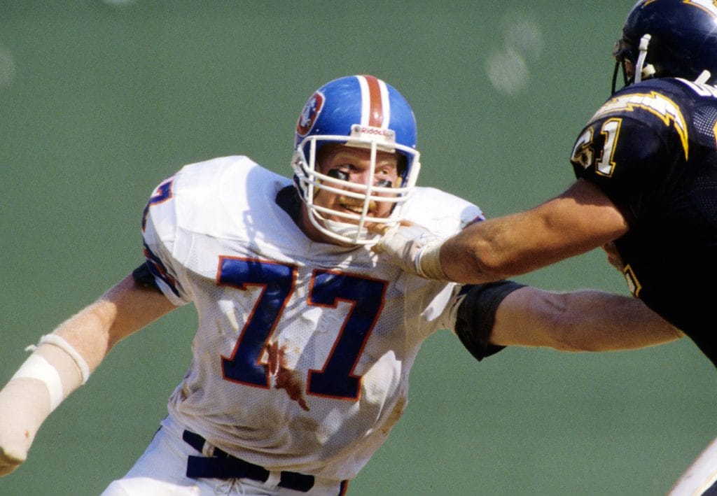  Karl Mecklenburg of the Denver Broncos engaged in a defensive play during an NFL game.