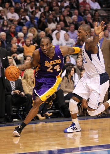 Kobe Bryant of the Los Angeles Lakers drives to the basket against the Dallas Mavericks in a dynamic offensive play.