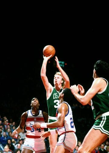 Larry Bird of the Boston Celtics shooting a fadeaway jumper against the Washington Bullets during an NBA game.