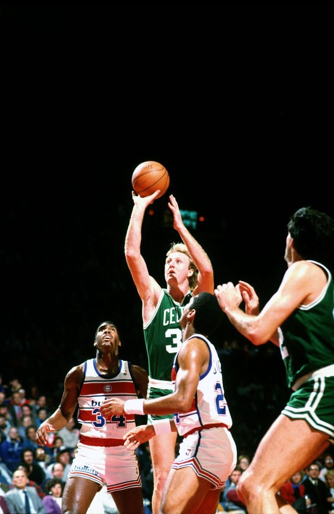 Larry Bird of the Boston Celtics shooting a fadeaway jumper against the Washington Bullets during an NBA game.