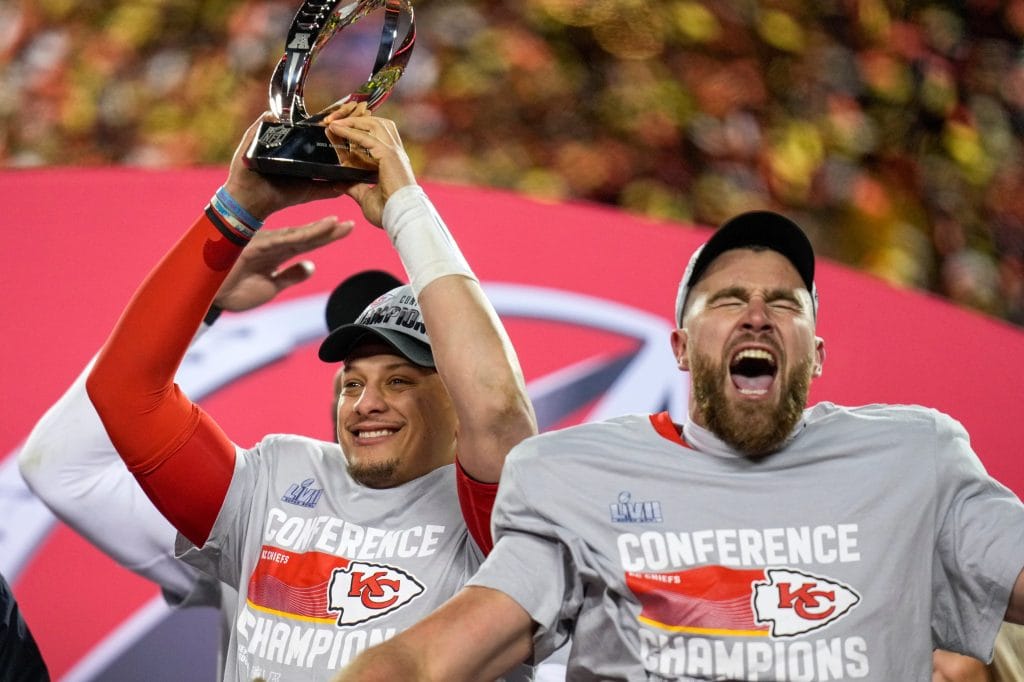 Patrick Mahomes and Travis Kelce celebrating with the AFC Championship trophy after their victory. The best white tight end of all time.