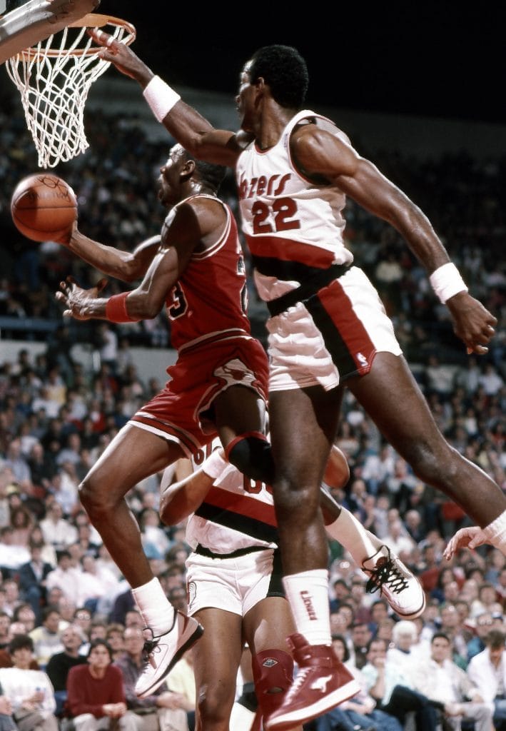 Michael Jordan performing a spectacular reverse layup against the Portland Trail Blazers, showcasing his creativity and scoring prowess.