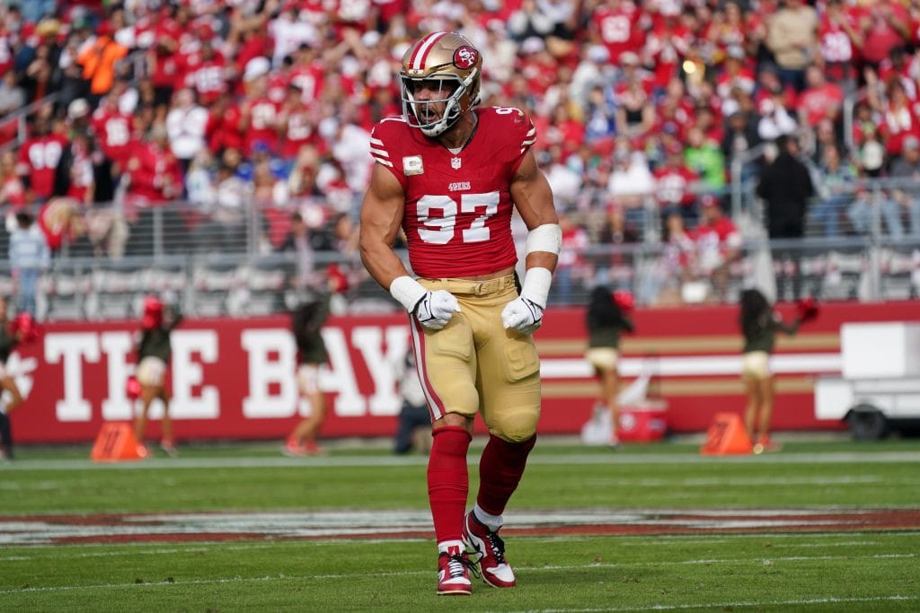 Nick Bosa celebrating on the field in his San Francisco 49ers uniform during a home game.
