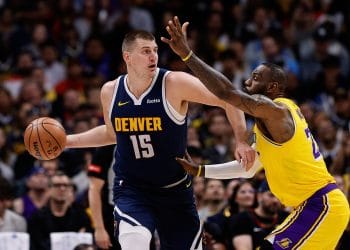 Nikola Jokic posting up for the Denver Nuggets against the Los Angeles Lakers and LeBron James, showcasing why he's one of the Top 10 White NBA Centers of All Time.