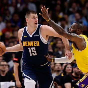 Nikola Jokic posting up for the Denver Nuggets against the Los Angeles Lakers and LeBron James, showcasing why he's one of the Top 10 White NBA Centers of All Time.
