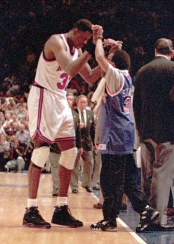 Patrick Ewing celebrates courtside with Spike Lee during a New York Knicks game at Madison Square Garden.