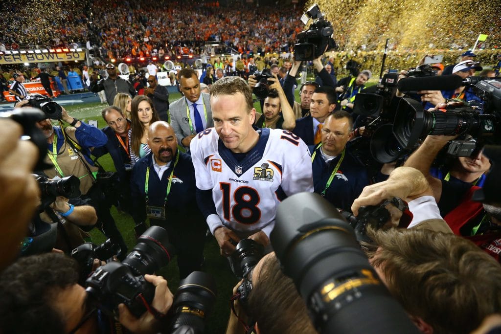Peyton Manning surrounded by media and confetti after winning Super Bowl 50 with the Denver Broncos.