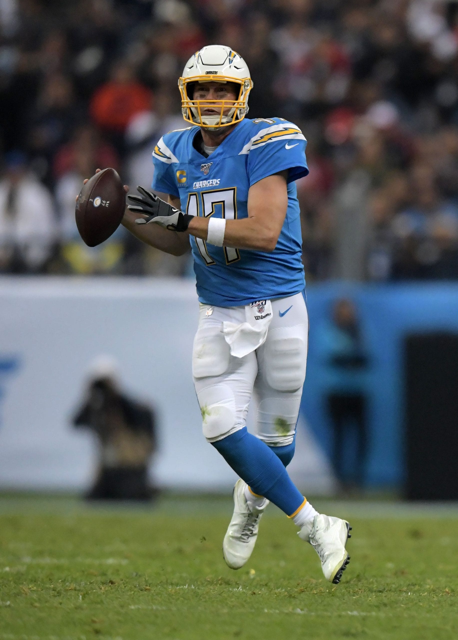 Philip Rivers mid-action, preparing to throw a pass while playing quarterback for the Los Angeles Chargers.