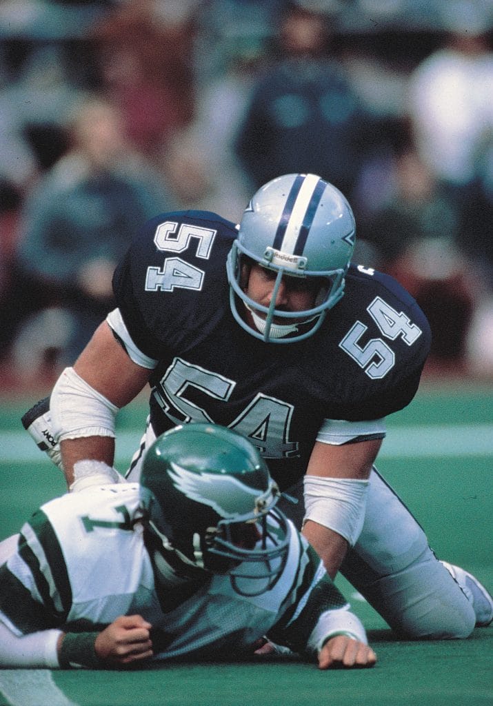 Randy White, one of the best white NFL players, tackles an opposing player while starring for the Dallas Cowboys.