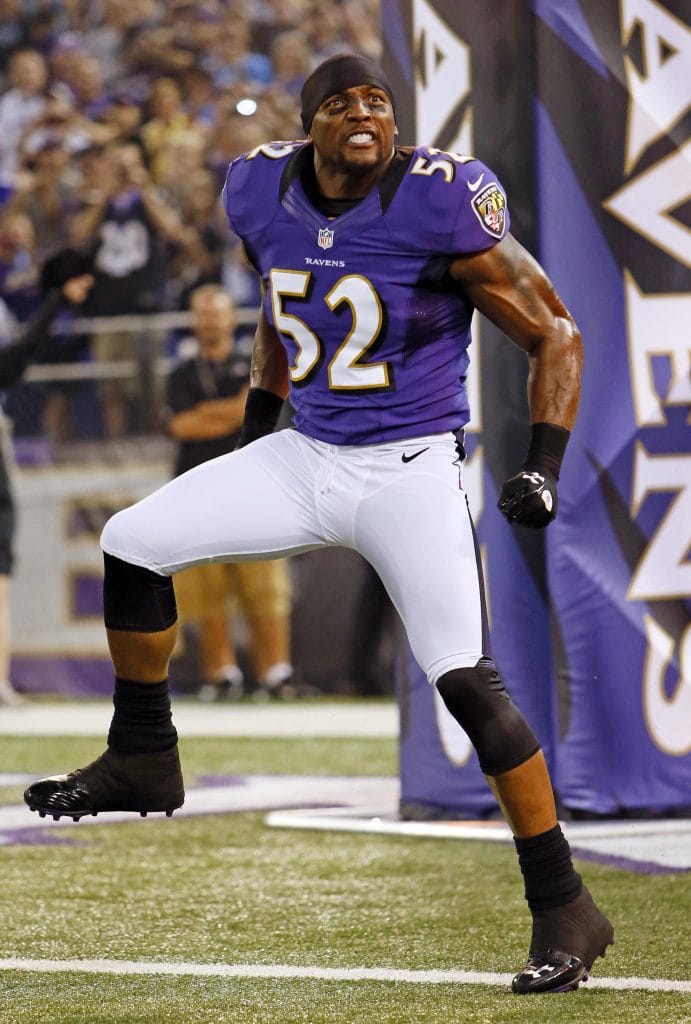 Ray Lewis of the Baltimore Ravens celebrates energetically on the field during a game, showcasing his iconic intensity.