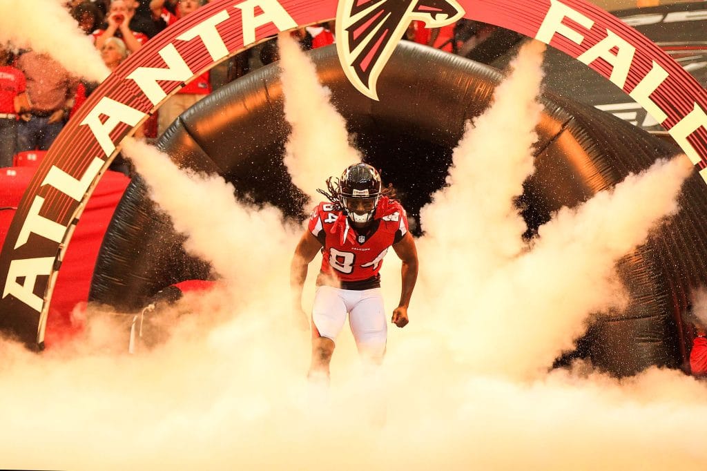 Roddy White of the Atlanta Falcons running out of the tunnel through smoke during pre-game introductions