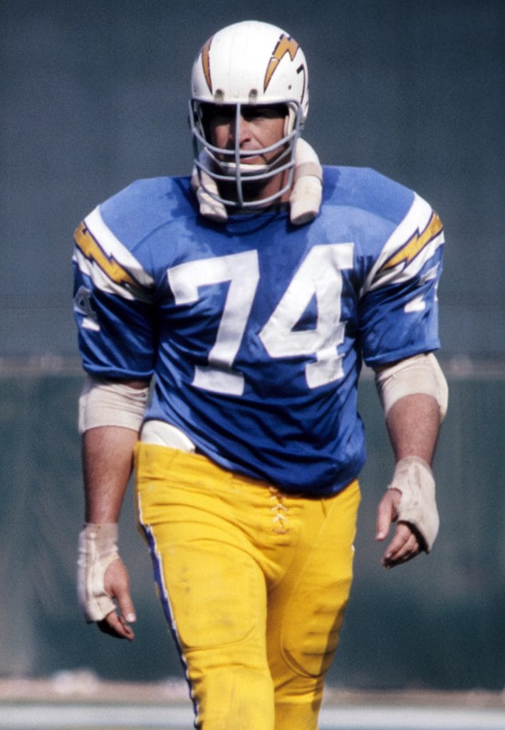 Ron Mix walking onto the field for the San Diego Chargers, showcasing his Hall of Fame career.
