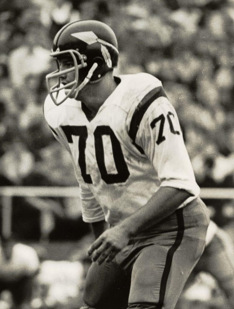 Sam Huff, wearing number 70, in action as a defensive lineman in a historical football game."