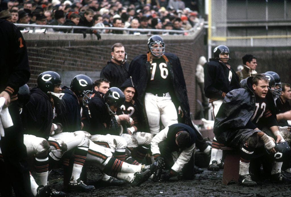 Stan Jones, a famous white NFL player, on the sideline with the Chicago Bears during a game.