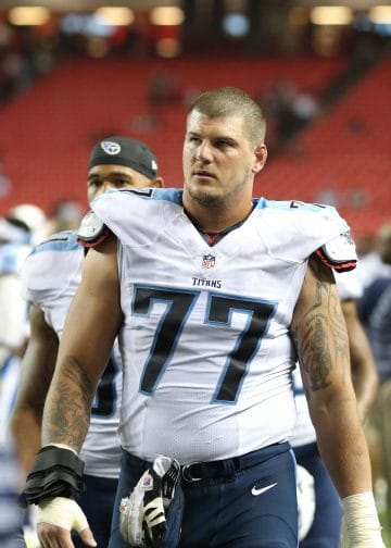 Taylor Lewan, Tennessee Titans offensive lineman, walks off the field after a game.