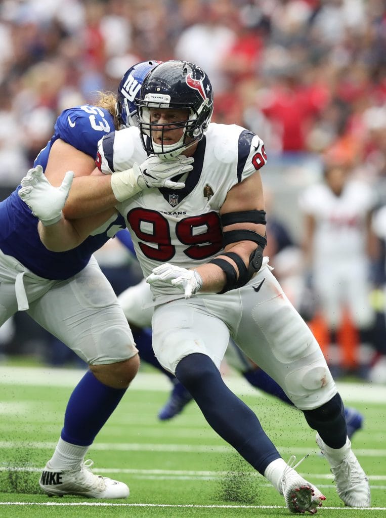 Houston Texans defensive end J.J. Watt battles against a New York Giants offensive lineman during a game.