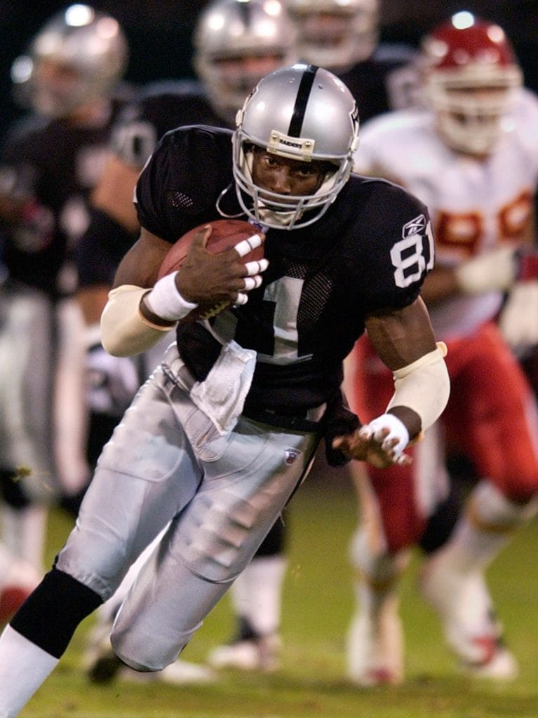 Tim Brown, legendary wide receiver for the Oakland Raiders, running with the football during a game.