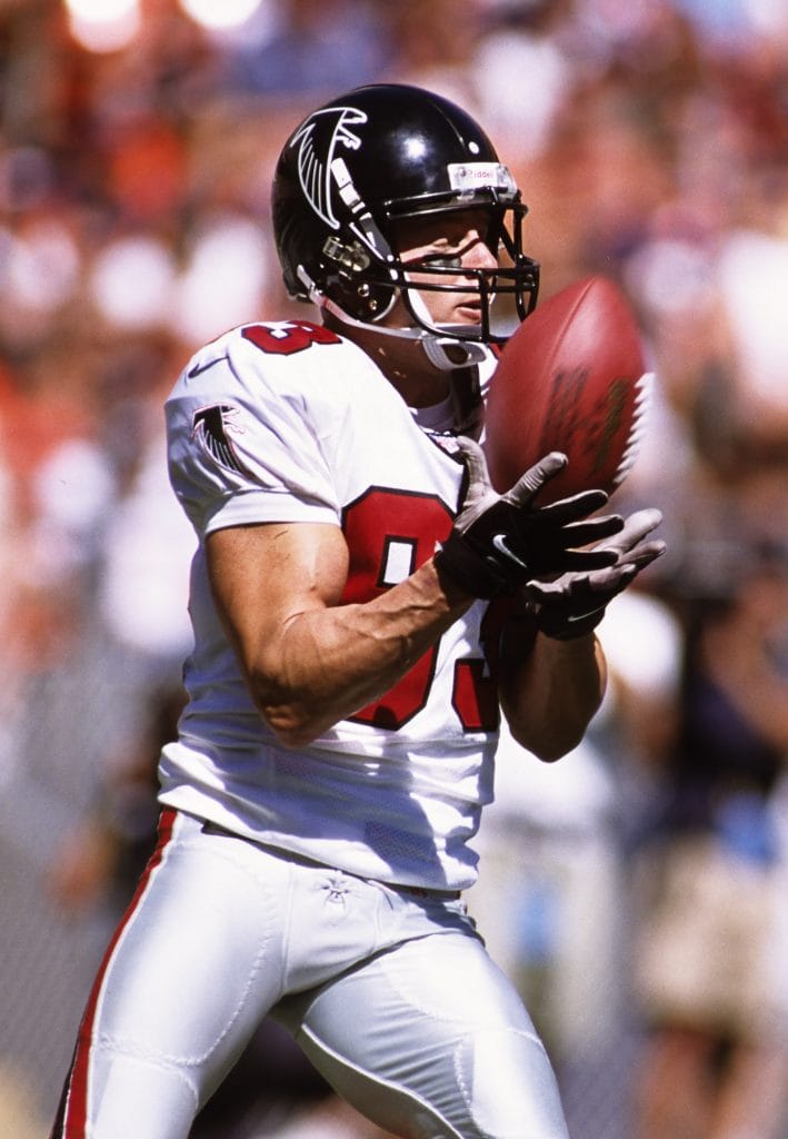 Tim Dwight fielding a punt in his Atlanta Falcons uniform during a regular-season game, showcasing why he ranks among the Top 10 White Kick Returners of All Time.