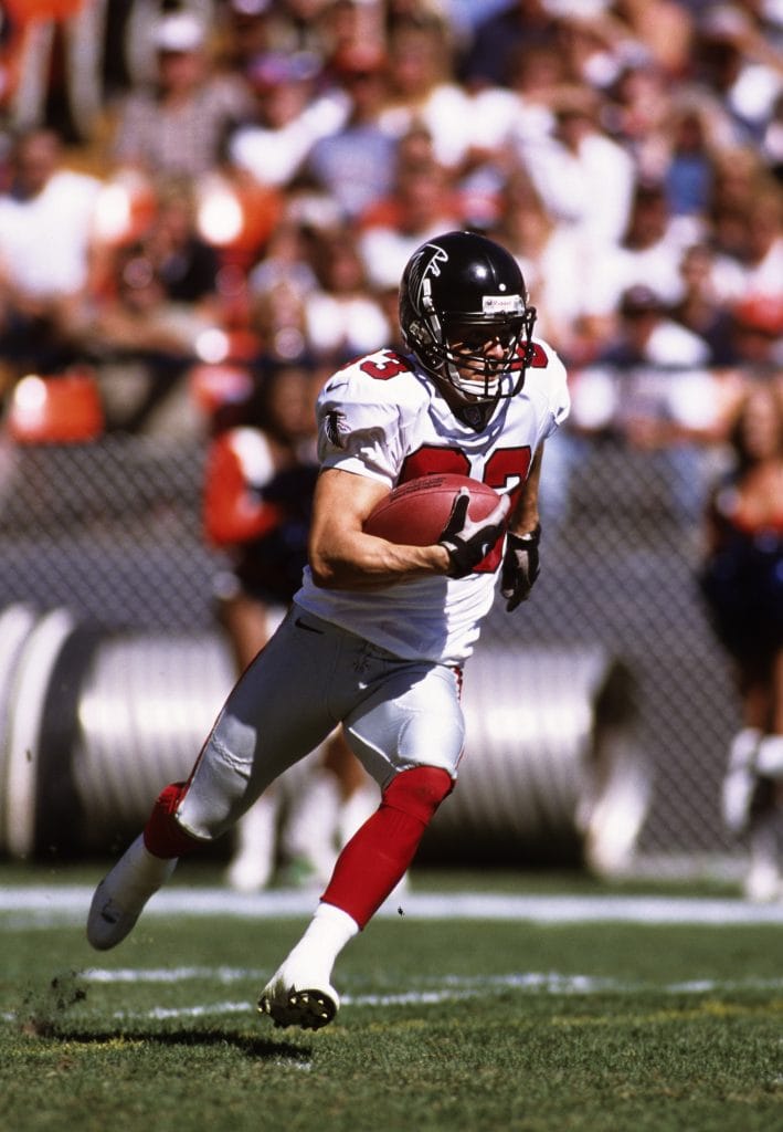 Tim Dwight returning a kick in his Atlanta Falcons uniform during a game.