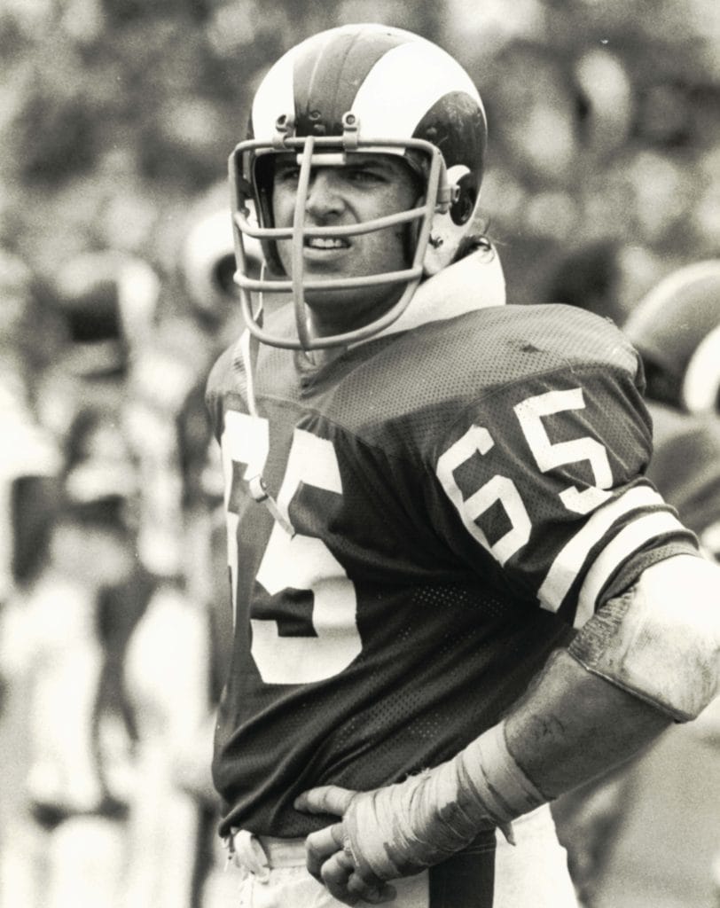 Tom Mack on the sideline for the Los Angeles Rams, known for his consistent performance as a left guard.