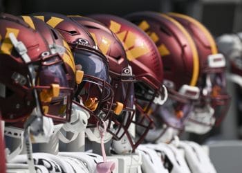 A row of Washington Commanders helmets on the sideline, representing the Top 10 Washington Commanders of All Time and their storied legacy.