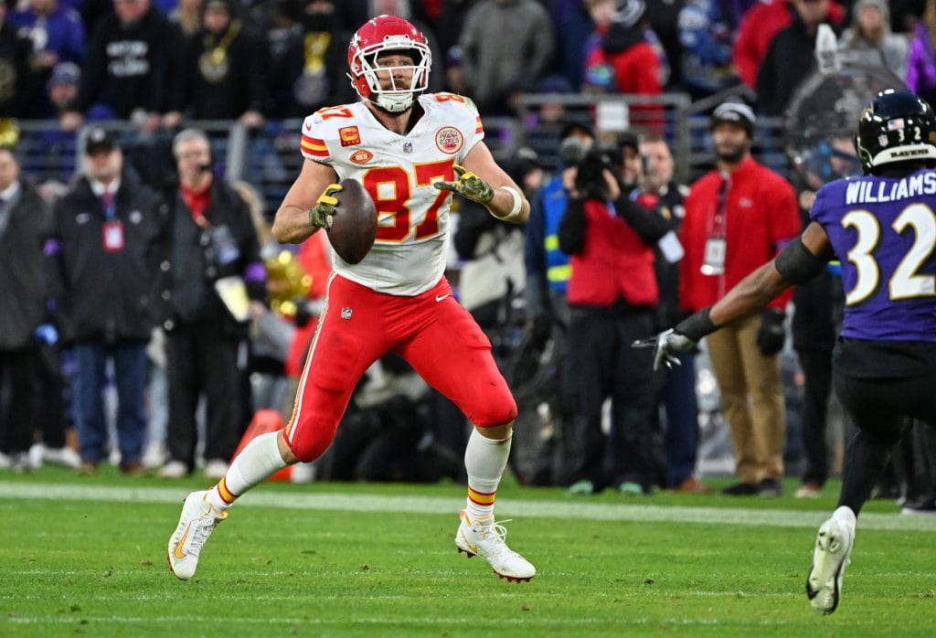 Travis Kelce prepares to throw a pass during a Chiefs game against the Ravens.