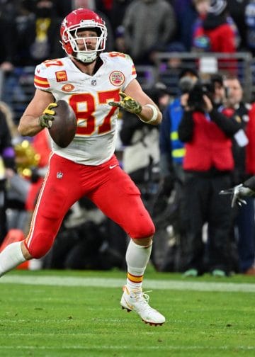 Travis Kelce prepares to throw a pass during a Chiefs game against the Ravens.