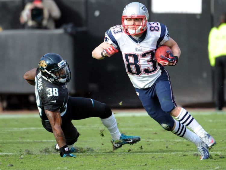 Wes Welker returning a punt in his New England Patriots uniform while evading a Jacksonville Jaguars defender.