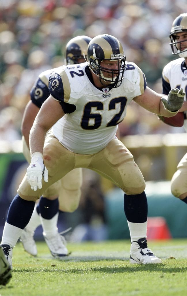 Adam Timmerman, a white NFL player and one of the best white right guards of all time, blocking during his time with the Rams.