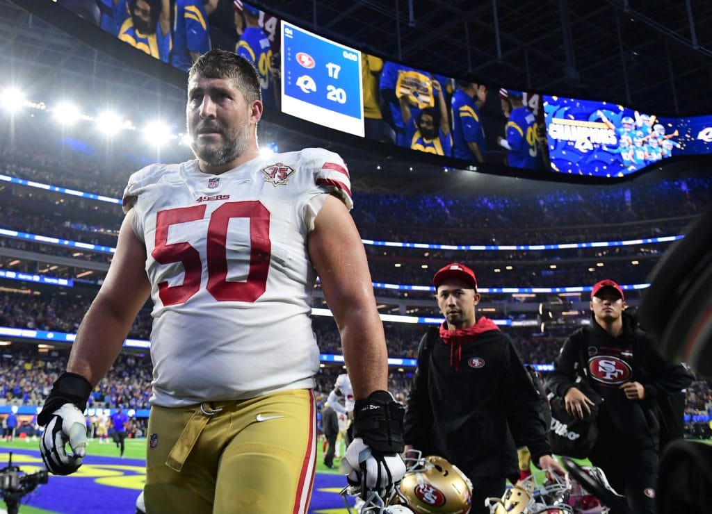 Alex Mack (#50) walks off the field as a leader of the 49ers' offensive line, a true standout among the best NFL white centers.
