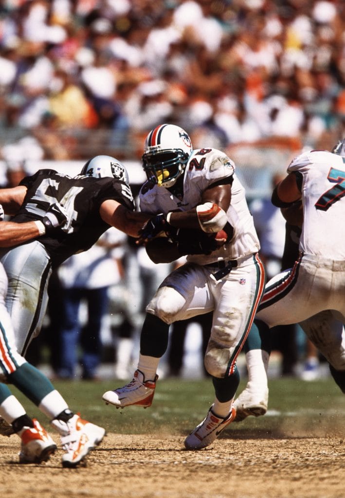 Greg Biekert making a crucial tackle, celebrated as one of the best white linebackers and famous white NFL players in history.