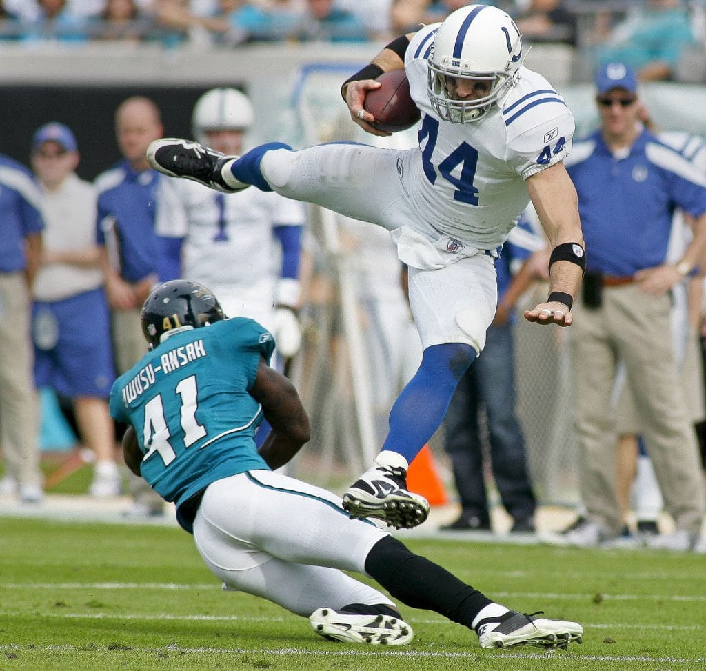 Dallas Clark, considered one of the best tight ends of all time, leaps over a defender during a game for the Indianapolis Colts.