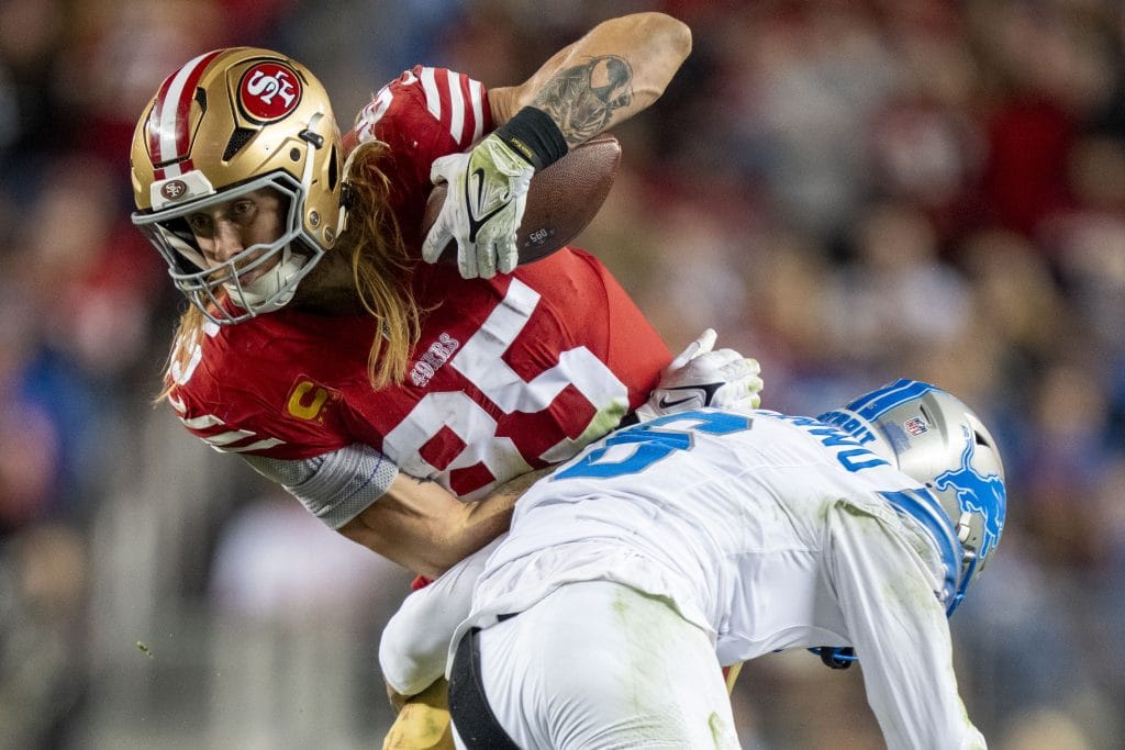 George Kittle, one of the best white football players, fights for extra yardage during a San Francisco 49ers game.