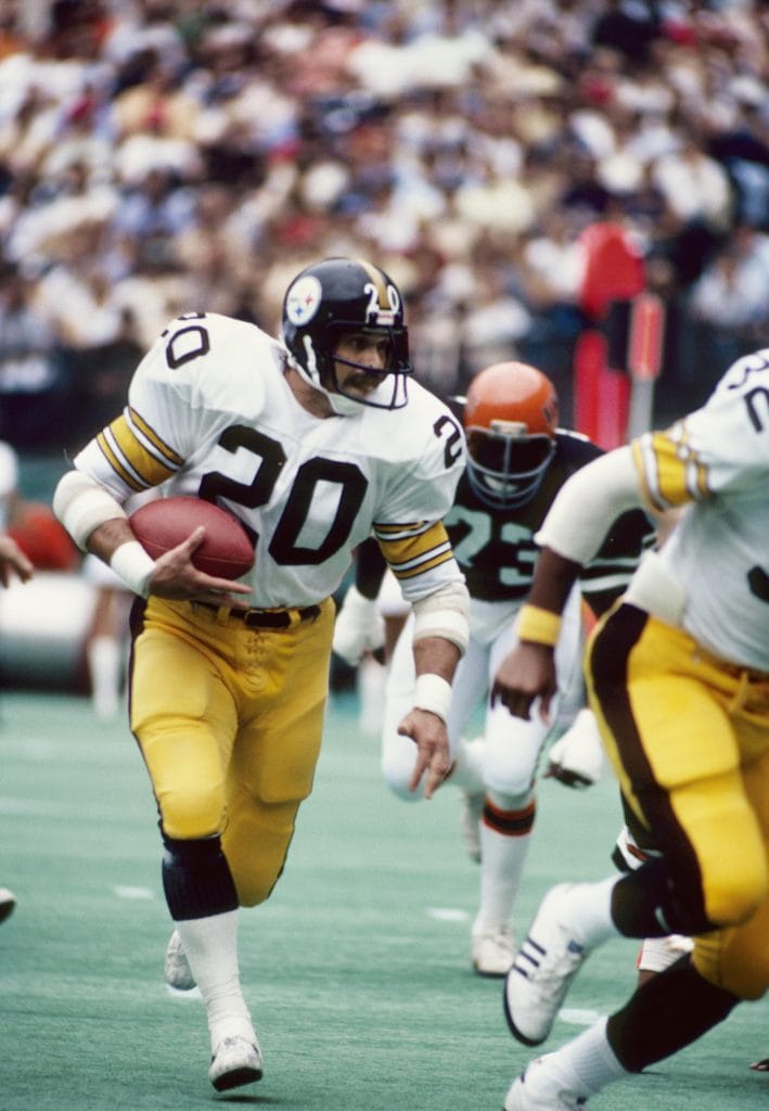 Rocky Bleier, famous white NFL player, carrying the ball for the Pittsburgh Steelers during a game.
