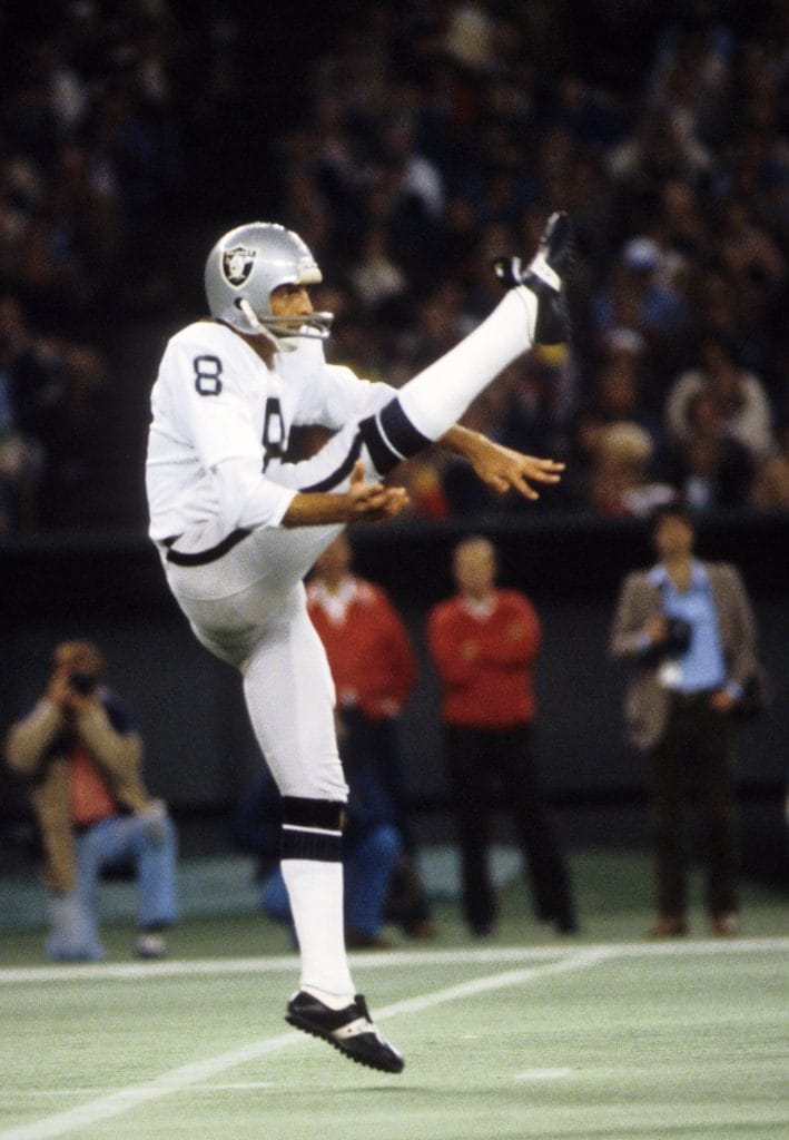 Ray Guy, one of the best white punters of all time, punting for the Raiders during an NFL game.