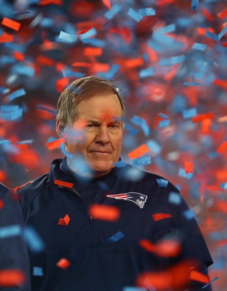Bill Belichick surrounded by confetti, celebrated as the best white coach in NFL history with six Super Bowl wins to his name.