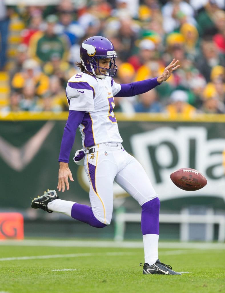 Chris Kluwe, best white punter in the NFL, punting for the Minnesota Vikings during a game.