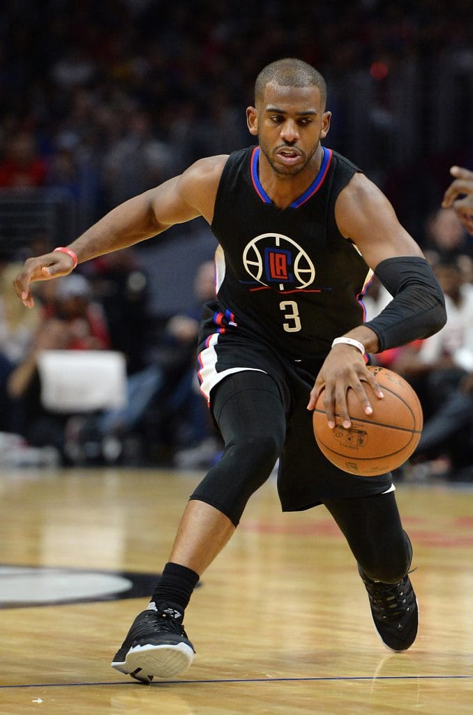 Los Angeles Clippers point guard Chris Paul driving to the basket while dribbling the ball during an NBA game.